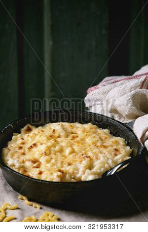 Classic American Dish Baked Mac And Cheese In Cast Iron Pan With Kitchen Towel And Ingredients Above