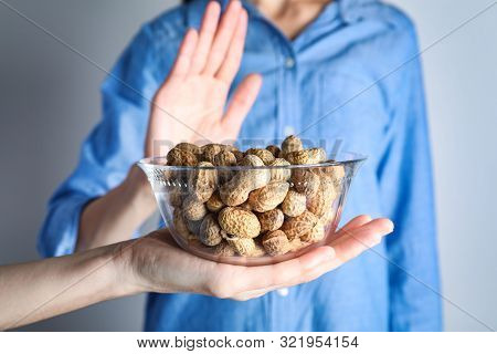 Woman Refusing To Eat Peanuts, Closeup. Food Allergy Concept