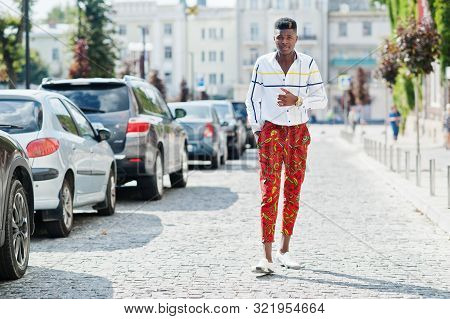 Portrait Of Handsome Stylish African American Model Man In Red Throusers And White Shirt Posed At St