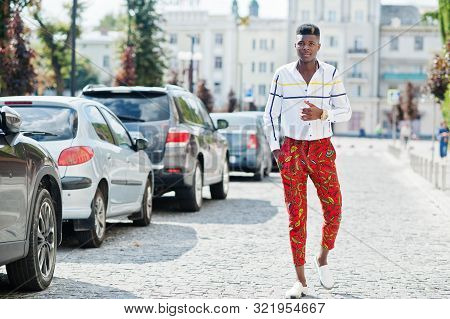 Portrait Of Handsome Stylish African American Model Man In Red Throusers And White Shirt Posed At St