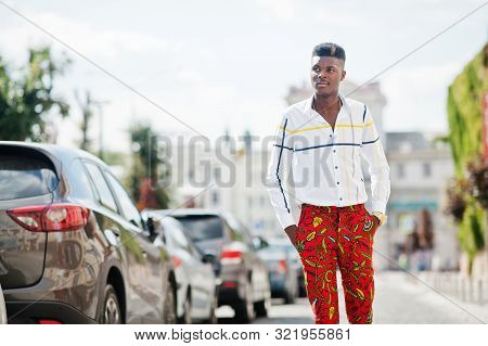 Portrait Of Handsome Stylish African American Model Man In Red Throusers And White Shirt Posed At St