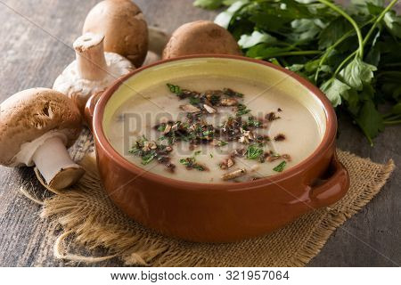 Homemade Mushroom Soup In Bowl On Wooden Table.