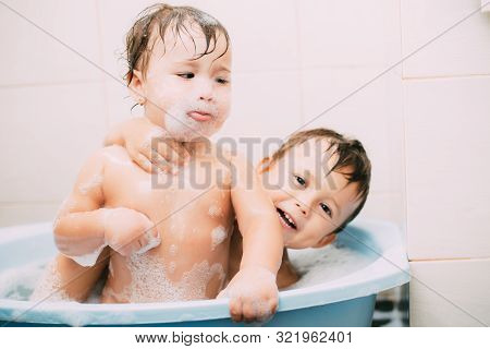 Children, Brother And Sister In The Bathroom Swimming, Playing Splashing