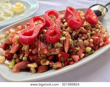 Turkish Salad Gavurdagi With Walnut, Tomatoes And Sliced Red Peppers Slices.