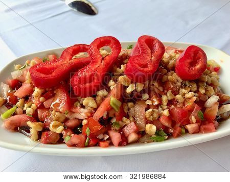 Turkish Salad Gavurdagi With Walnut, Tomatoes And Sliced Red Peppers Slices.