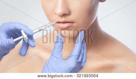 A Cosmetologist Is Making The Lips Augmentation Procedure  In A Beauty Salon.cosmetology Skin Care.