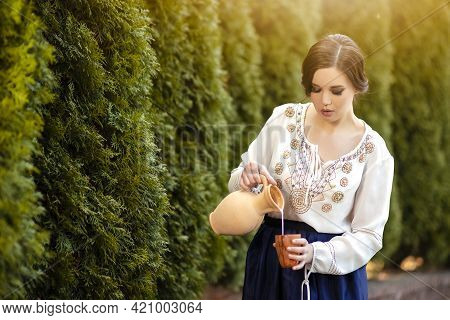 Portrait Of Sexy Brunette Girl In Village Dress Picking Colorful Kidney Beans On Table In Village En