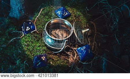 Role-playing Game Scene Of A Metallic Kettle Miniature Surrounded By 8-sided Dice On Green Moss