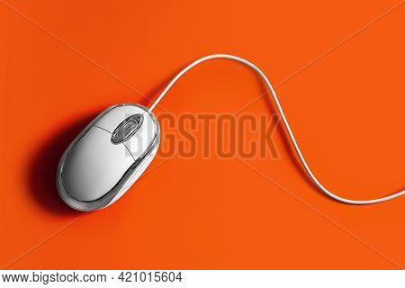 Computer Mouse. Wired Computer Mouse On An Orange Background, Top View. Copy Space. Minimal Flatlay 