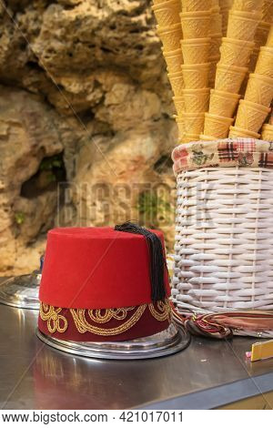 Traditional turkish dondurma ice-cream stand with sellers hat close-up in Turkey.