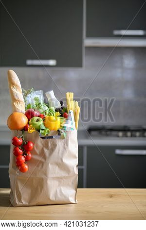 Full Paper Bag With Healthy Food On The Background Of The Kitchen.healthy Food Background.supermarke