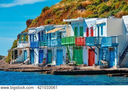 Scenic picturesque greek fishing village Klima with whitewashed traditional houses and colorful windows and doors on Milos island in Greece