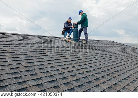 Construction Workers Installing Chimney And Building Construction Concept. Contractor Builder With B