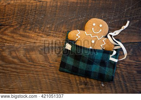 Gingerbred Man Tucked Into Plaid Sleeping Bag With Ribbon