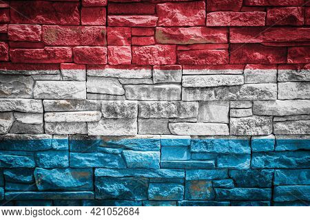 National Flag Of Luxembourg On Stone  Wall Background.the Concept Of National Pride And Symbol Of Th