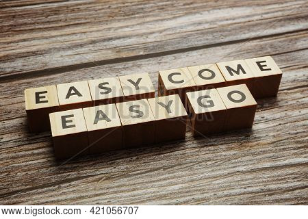Easy Come  Easy Go Alphabet Letters On Wooden Background