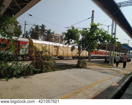 Closeup Of Trains, Platform, People Walking And Name Board Of Railway Station Of Channapatna