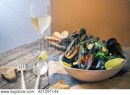 Blue Mussles With Vine And Baguette On Wooden Table