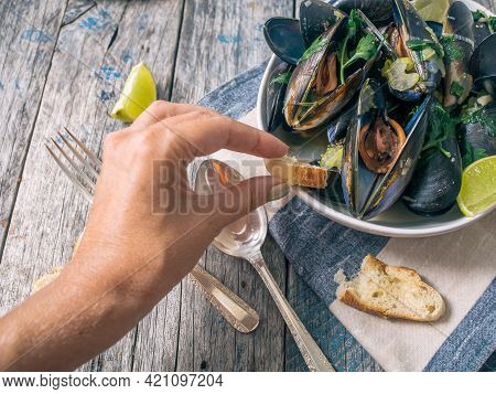 Blue Mussles With Vine And Baguette On Wooden Table