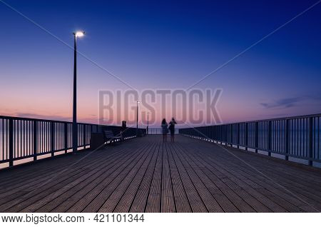 Pier On The Sea Coast - Womens Walk At A Quiet Sunset