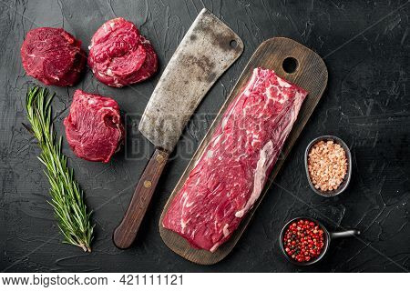 Gourmet Portion Of Raw Fresh Marbled Beef Fillet Set , With Old Butcher Cleaver Knife, On Black Ston