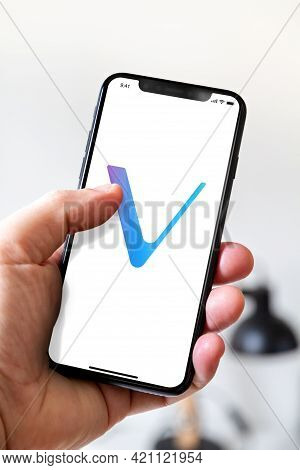 Paris - France - March 23, 2021 : Hand Holding Iphone Smartphone With Vet Vechain Crypto Currency Lo