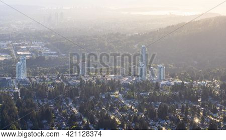 Aerial View From Airplane Of Residential Homes And Buildings In A Modern City During Sunny Evening. 