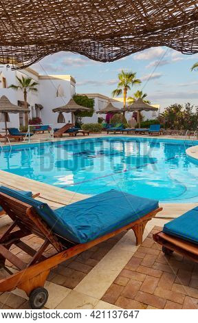 Man jums into the swimming pool in african camping