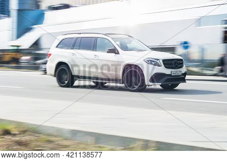 White Mercedes Gl Class X166 On The City Road. Fast Moving Car On The Street. Vehicle Driving Along 