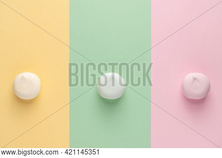 Colorful Marshmallows On Three Different Colors Backgrounds (yellow, Green, Pink). Top View, Flat La