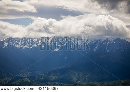 Heavy Clouds Over The Bucegi Mountains In Romania During A Spring Day, As Seen From The Hills Of Pes