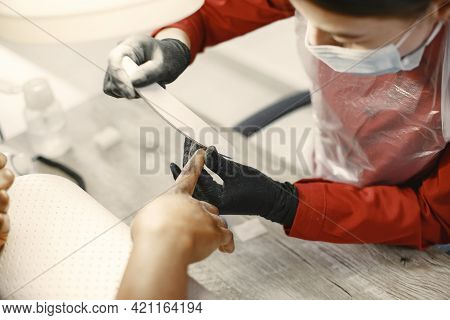 African Girl Doing Manicure In A Beauty Salon