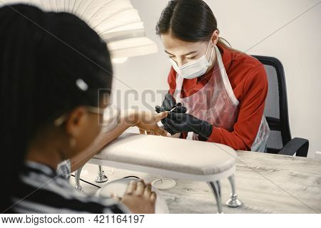 African Girl Doing Manicure In A Beauty Salon