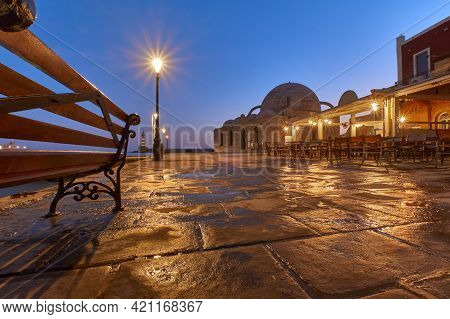 Old Venetian Port Xania Creta Greece Towards To The Lighthouse In Twilight, A Bench Restaurants Anci