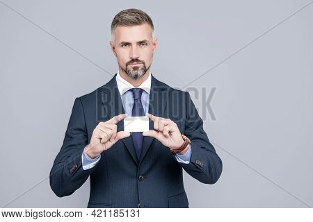 Mature Man Banker With Grizzled Hair In Suit Showing Credit Or Debit Card Copy Space, Manager