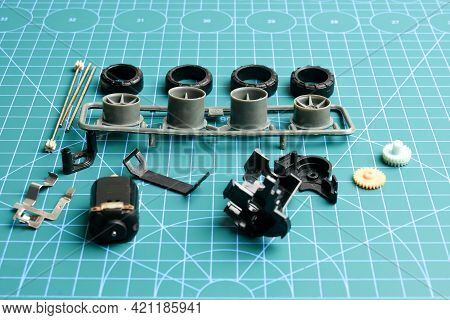 Small Component Of Mini 4wd Toy Car On Cutting Mat Before Assembly.