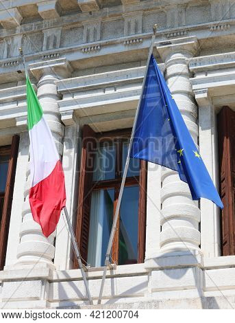 Two Flags One Italian And One European Flying Outside The Historic Building During The International