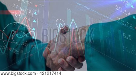 Statistical and stock market data processing against mid section of surgeons shaking hands. global finance and healthcare concept