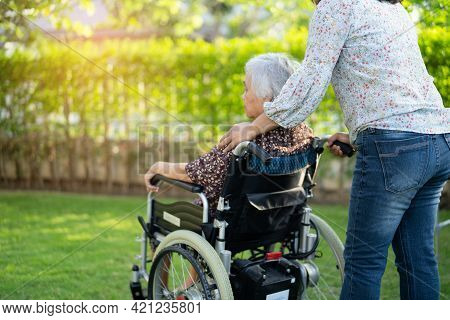 Doctor Help And Care Asian Senior Or Elderly Old Lady Woman Patient Sitting On Wheelchair At Park In
