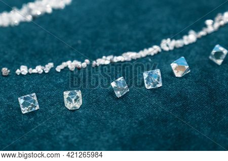 Several Large Diamonds Lie On The Turquoise Velvet. Close-up Photo. Cut Diamond.