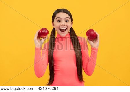 Surprised Child With Red Apple On Yellow Background, Dieting