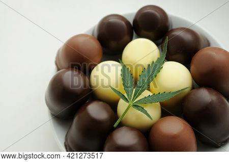 Cbd Chocolate Sweets With Cannabis Leaf. Hemp Stuff Isolated On White Table. Concept Of Cooking With