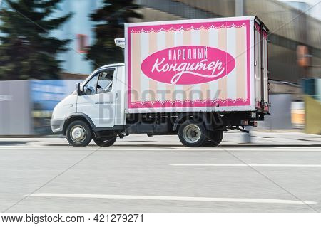 Small Cargo Van Gaz Gazelle With Inscription In Russian Narodny Konditer On The Car Body. Fast Movin