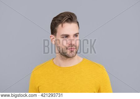 Good-looking Young Man Portrait With Unshaven Face In Yellow Sweater Grey Background, Handsome