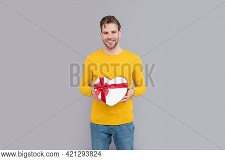 Happy Valentines Day. Man Smile Holding Heart-shaped Gift Box. Valentines Day Present