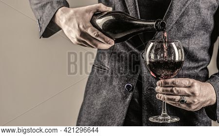 Gourmet Drink Bottle, Red Wine Glass, Sommelier, Tasting. Waiter Pouring Red Wine In A Glass. Sommel