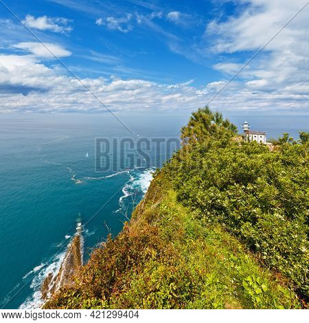 Getaria Lighthouse Is Located At The End Getaria Mouse (symbol Of Town), On Mount San Anton. Spain, 