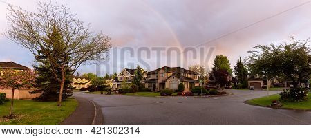 Street And Homes View At A Quite Residential Neighborhood In Suburban Area Of A Modern City. Colorfu