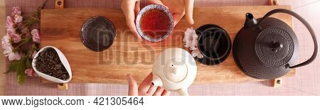 Master And Guest With Freshly Brewed Tea During Traditional Ceremony At Wooden Table, Top View. Bann