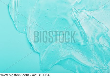 Gel With Hyaluronic Acid In The Form Of A Smear Of Glossy Texture On A Cyan Background. Antibacteria